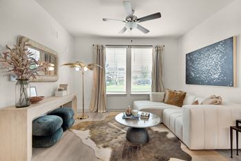 a living room with a white couch and a ceiling fan at The Enclave at Deer Moss Creek, Niceville, Florida